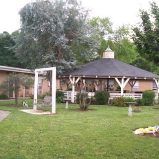 A picturesque garden featuring a gazebo with surrounding greenery.
