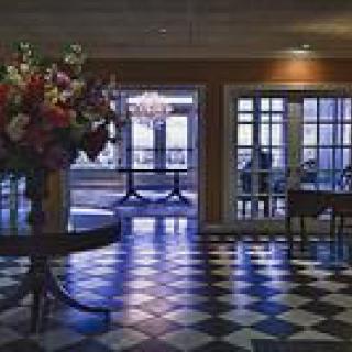 A stylish hotel lobby featuring a checkered floor and elegant decor.