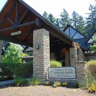 Main entrance of a building surrounded by trees with a visible sign.