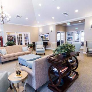 A spacious and well-lit living room with comfortable seating and modern decor.