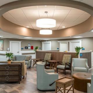 A modern and comfortable waiting area with seating and a reception desk.