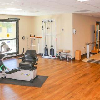An indoor gym with various exercise equipment and workout machines.