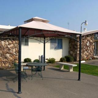 An outdoor gazebo with patio furniture providing a shaded seating area.