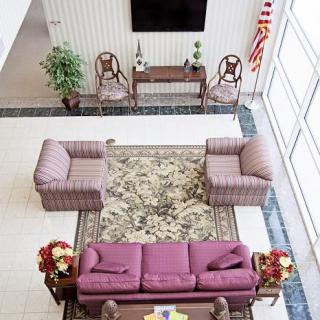 A well-furnished lobby area featuring comfortable seating and decorative elements.