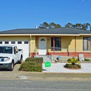 A suburban house with a truck parked in the driveway.