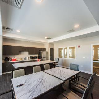 A modern kitchen and dining area with a table and chairs, featuring contemporary interior design.
