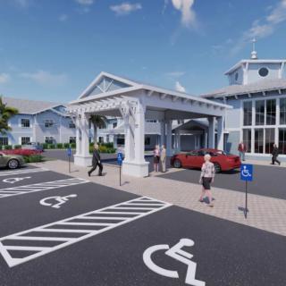 A building with a covered entrance, surrounded by a parking lot with accessible parking spots and several people walking nearby.