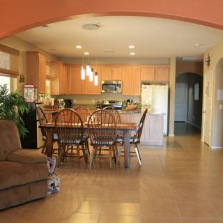 A modern kitchen and dining area with wooden furniture and an open floor plan.