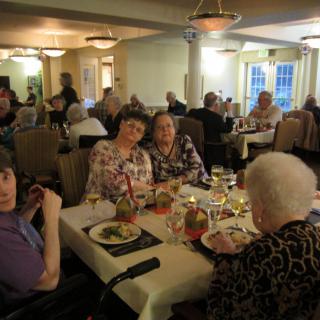 A group of seniors enjoying a meal together at a restaurant.