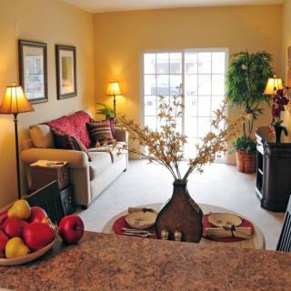 A cozy living room with warm lighting, a comfortable sofa, and elegant decor.