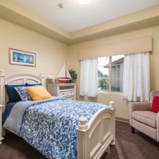 A cozy bedroom with a single bed and calming decor.