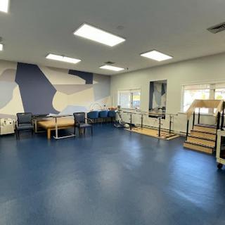 A spacious therapy room designed for rehabilitation with modern amenities and a calming color scheme.