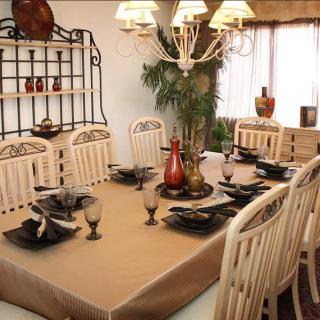 A well-decorated dining room with an elegant table setting and chandelier.