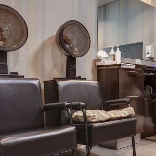 Vintage salon with hair dryers and comfortable seating.