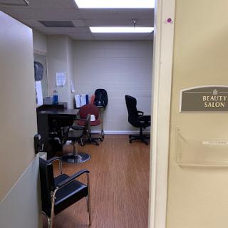 A glimpse into the interior of a beauty salon, showcasing waiting chairs and a clean, organized space.