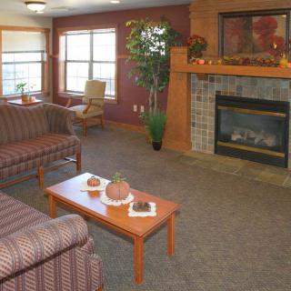 A cozy living room with a fireplace, sofa, and coffee table.