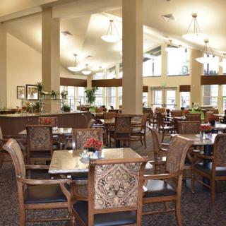 A spacious and well-lit dining area with elegant tables and chairs.
