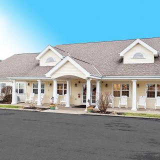 An exterior view of a residential building with a pitched roof and covered porch.