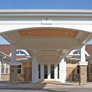 A covered entrance with columns leading to a building.