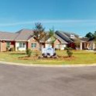 A suburban house with a well-maintained lawn and landscaping.