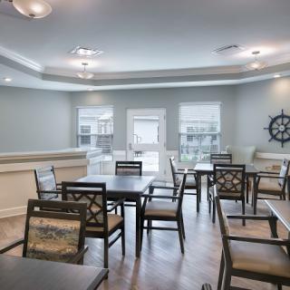 A modern dining area featuring tables and chairs, designed for communal gatherings.