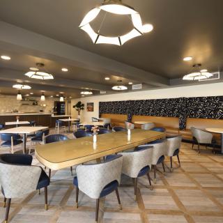 A modern restaurant interior featuring stylish lighting and a comfortable dining area.