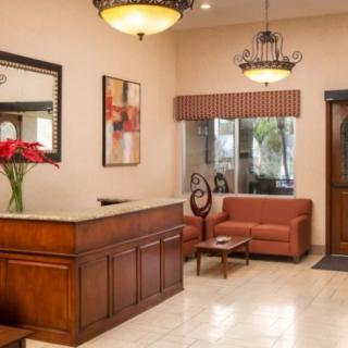 A welcoming hotel lobby with a reception desk, sofas, and elegant decor.