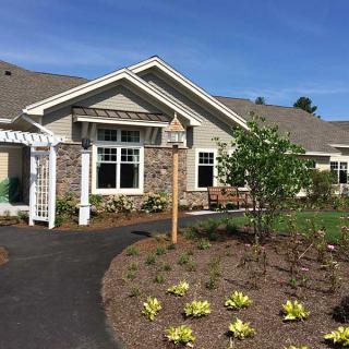A suburban house with well-maintained landscaping and a garden.