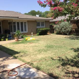 A suburban house with a neatly maintained lawn and garden.