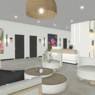 A modern and minimalist lobby area with comfortable seating, a reception desk, and decorative artwork.