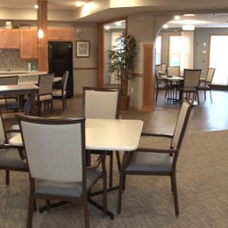 A spacious and inviting dining area featuring modern furniture and ample natural light.