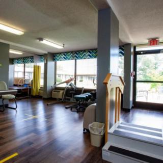 An interior view of a rehabilitation clinic with exercise equipment.