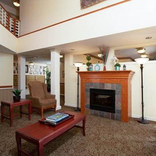 A cozy living room interior with a fireplace and comfortable seating.