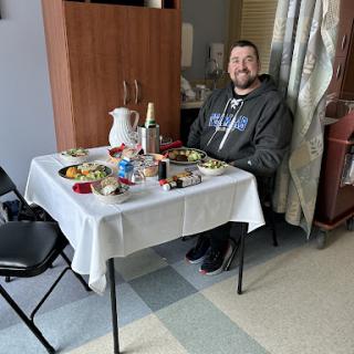 A patient enjoying a meal in a hospital setting.