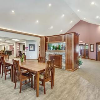 A spacious dining area with modern wooden furniture and ambient lighting.