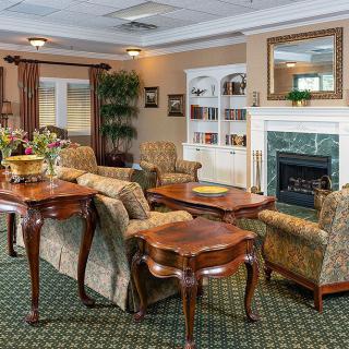 A traditional style living room with elegant furniture and a fireplace.