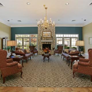Elegant living room with a chandelier and comfortable seating.
