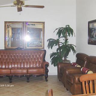 A cozy living room with leather furniture and decor.