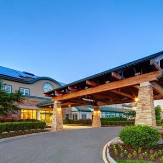 The entrance of a modern hotel showcasing elegant architectural design.