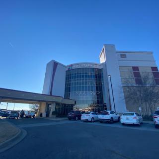 A modern healthcare facility showcasing contemporary architecture under a clear blue sky.