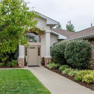 A welcoming house entrance with well-maintained landscaping.
