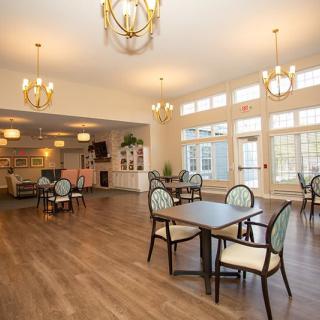A spacious dining area with elegant lighting and modern furniture.