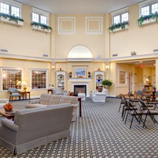 A spacious and elegantly decorated living room with a fireplace and comfortable seating.