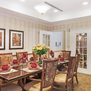 A well-decorated dining room with an elegant table setting and floral centerpiece.