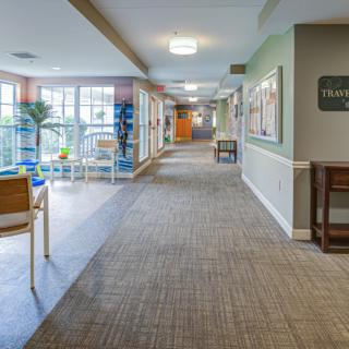 A well-lit hallway with chairs and decorative elements.