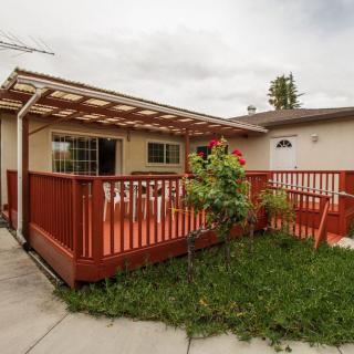 A house with a wooden deck and garden area.