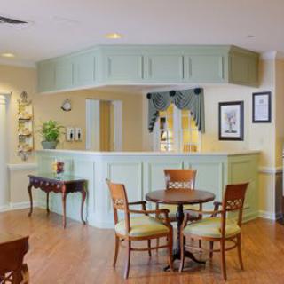 A cozy reception area with a round table, chairs, and decorative elements.