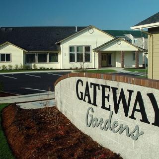 A view of the Gateway Gardens residential complex sign and buildings.
