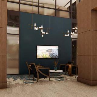 A modern lobby interior with sleek furniture, stylish lighting, and a feature wall.