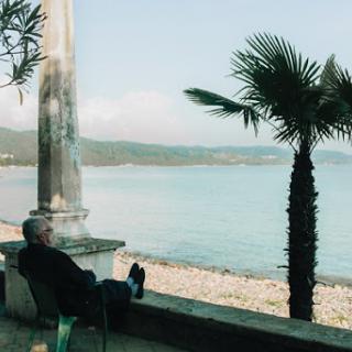 A serene moment by the water, enjoying the gentle breeze and beautiful scenery.